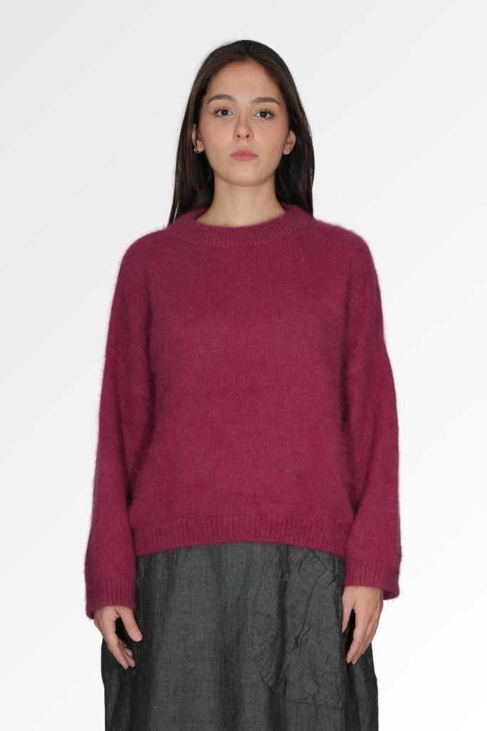 Olga de Polga cosy Women's Montreal Sweater in Angora in a soft purple plum colour. Long sleeves, cropped length, round neckline, dropped shoulders. Ribbing at neckline, cuffs and hem. Front view on model