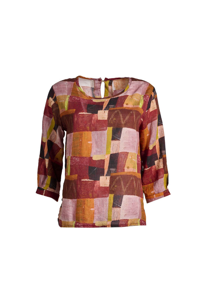 Olga de Polga Chemise blouse in cotton seersucker. In the printed Kismet Blush print with reds, oranges and pinks from the AW25 Odyssey collection. 3/4 length sleeves, round neckline, back neck button opening. Front view