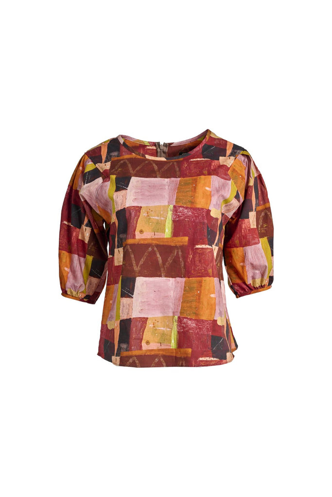Olga de Polga classic printed blouse in Kismet Blush print. Pinks, reds and burgundy with accents of yellow and orange. Round neckline and lantern shaped sleeves. Front view