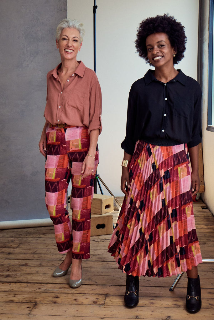 Olga de Polga Printed Pantalon pants in Kismet Blush. Front view on model with another model in the pleated skirt option.