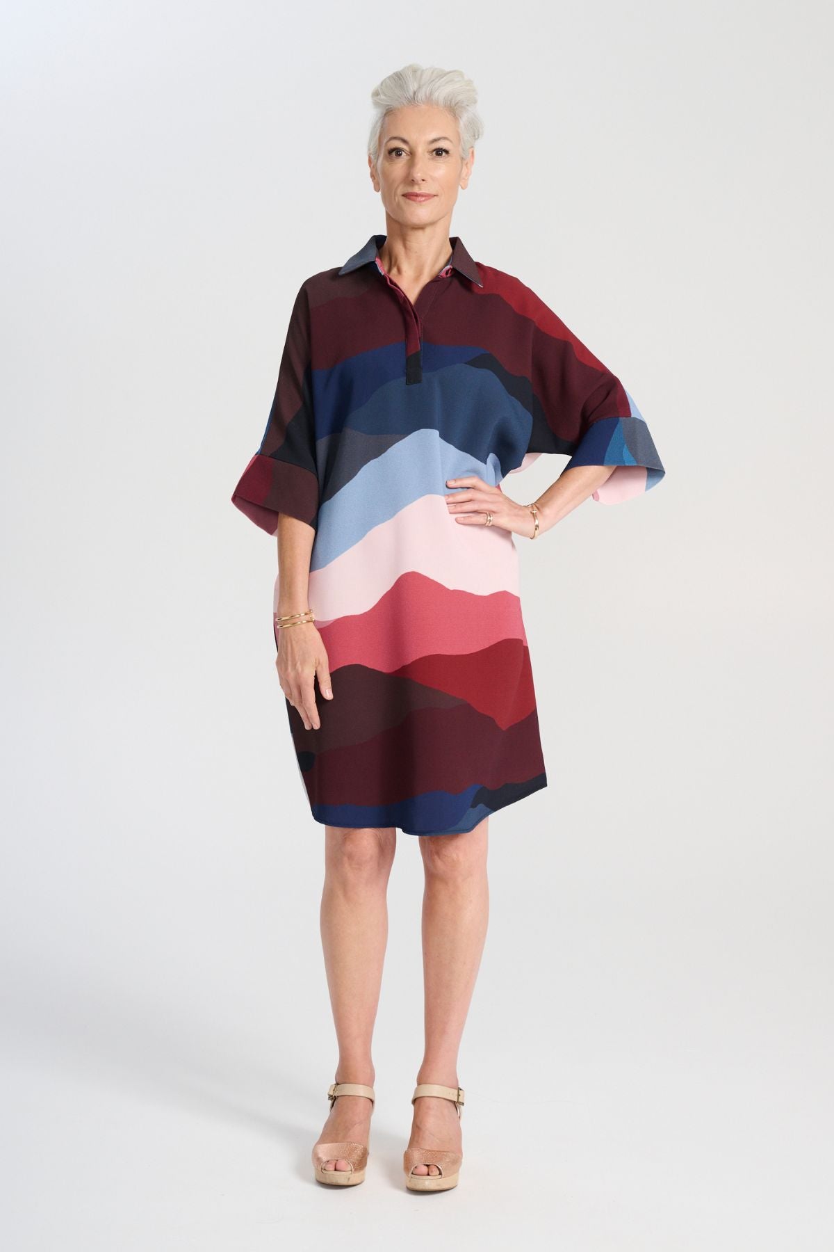 Olga de Polga Kona Skylone Estilo Shift dress in heavy crepe. With a shirt collar and buttons at the neck. Half sleeves with a batwing shape. Knee length. Front view on model