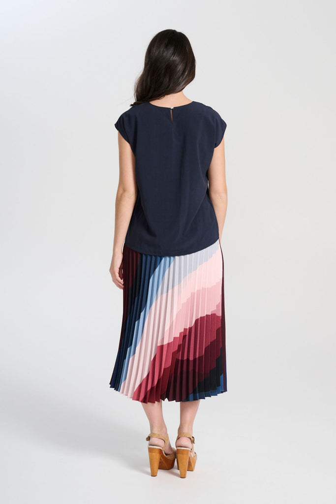Olga de Polga Kona Printed pleated skirt with an elasticated black waistband. Back view on model.