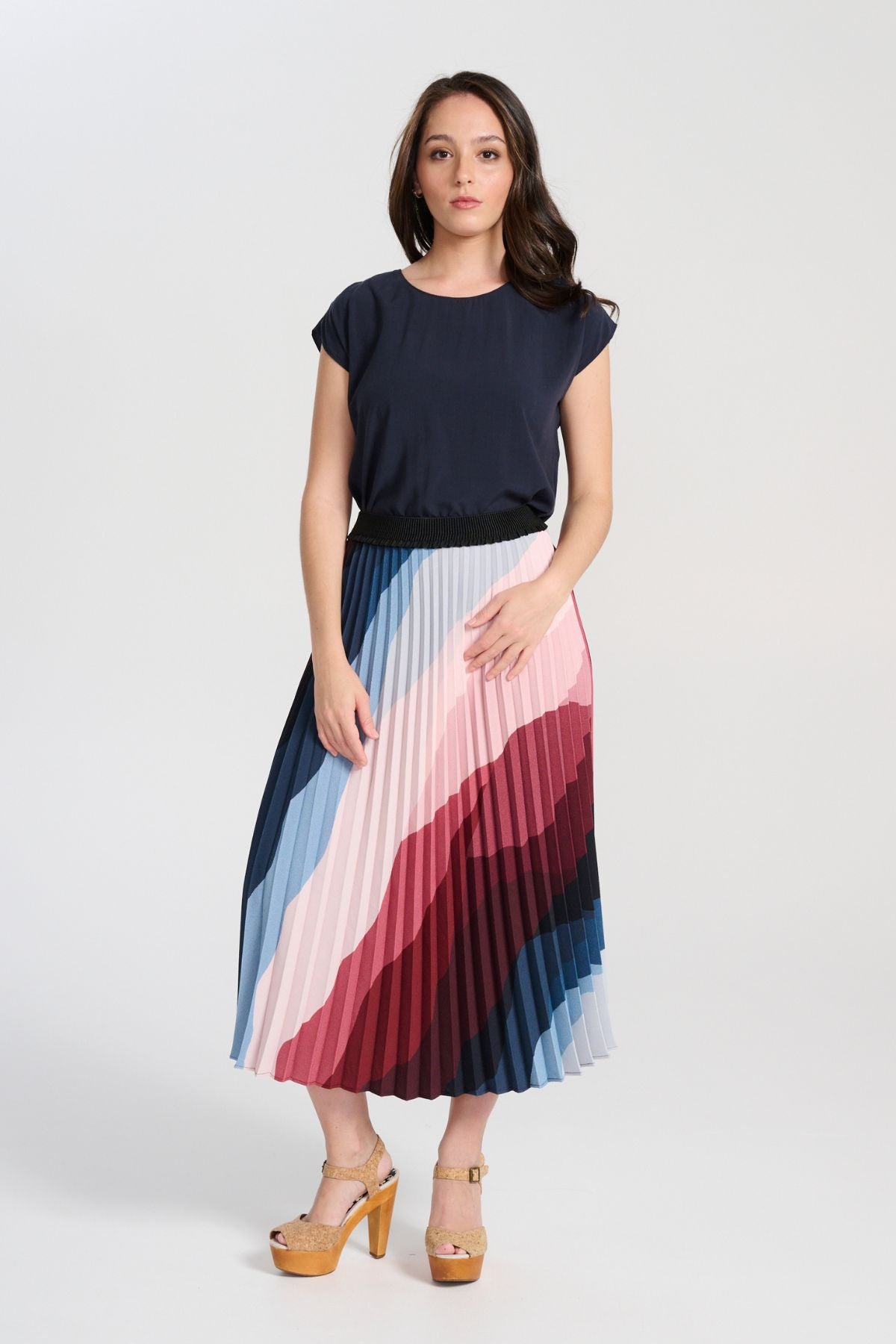 Olga de Polga Kona Printed pleated skirt with an elasticated black waistband. Front view on model