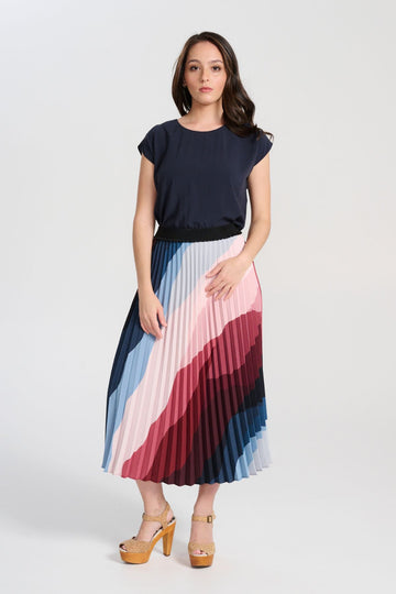 Olga de Polga Kona Printed pleated skirt with an elasticated black waistband. Front view on model