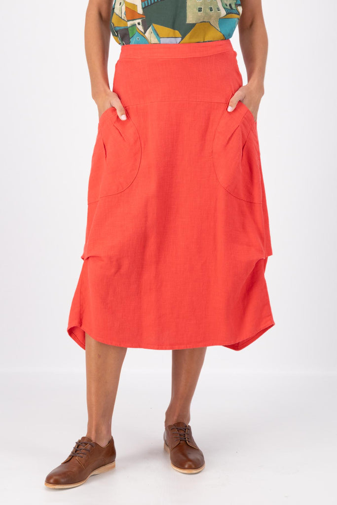 Olga de Polga Milwaukee Fiesta skirt in Watermelon Red.  Milwaukee Fiesta Skirt in 100% slub linen is an incredibly unique, chic and original skirt. It is universally flattering, highly versatile, and super comfortable. Perfect to throw on and go. Front view on model.