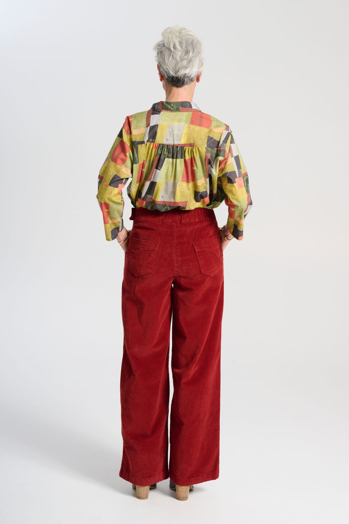 Olga de Polga Red Peggy Sue Long Pants in Vino. Made in soft cotton velvet corduroy. Back elastic waist, front flat waistband. Large patch pockets. Back view on model