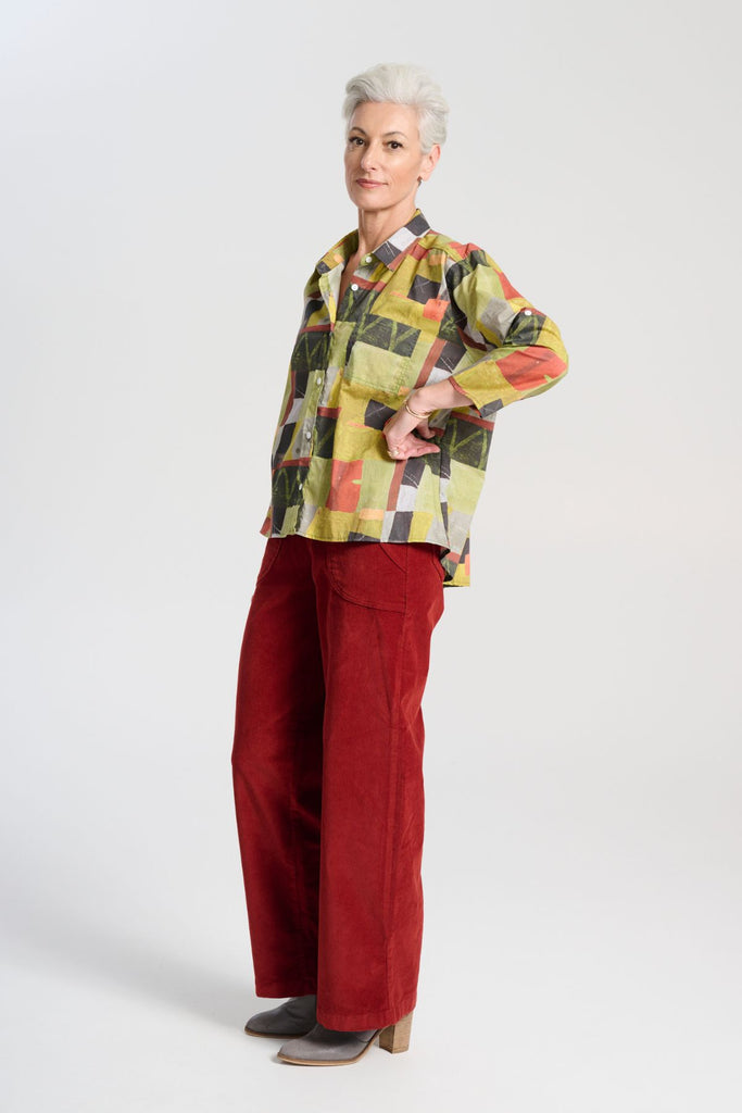 Olga de Polga Red Peggy Sue Long Pants in Vino. Made in soft cotton velvet corduroy. Back elastic waist, front flat waistband. Large patch pockets. Side view on model.