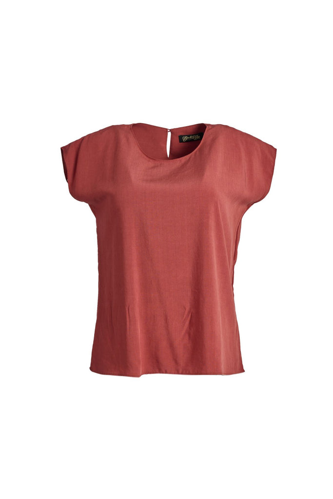 Olga de Polga Rust red tee in 100% soft Tencel. Classic Olga tee with cap sleeves and a button opening at the bak neck. Tapers in at the waist, and finishes at the hip. Front view