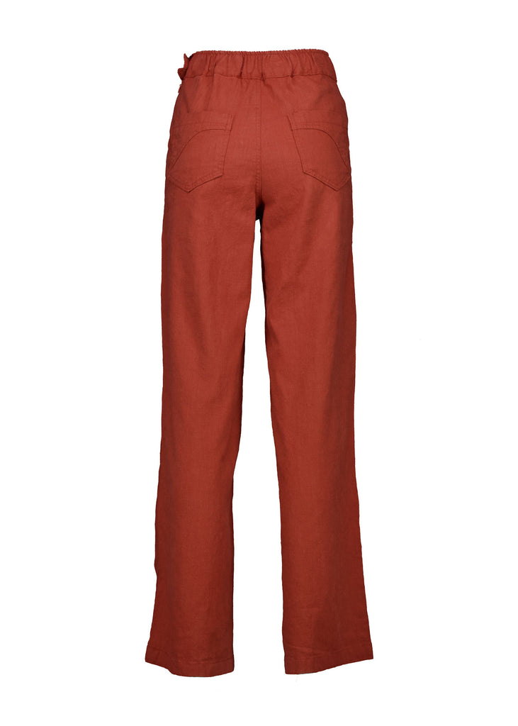 Olga de Polga Peggy Pants Long Lino in Rose Brick linen. Featuring a flattering high waist with an elasticated back, these pants provide all-day comfort while maintaining a sleek, streamlined look. With their stretchy wide-leg fit, flat front, and full-length silhouette, they effortlessly elevate any outfit. Back view.