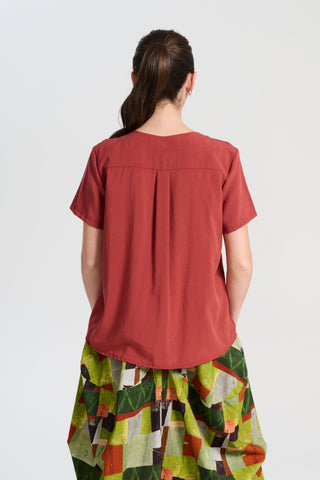 Olga de Polga Rhea Top in Rust. 100% Tencel. Round neckline and short sleeves. A boxy t-shirt shape in a soft silky Tencel fabric. Back close-up view