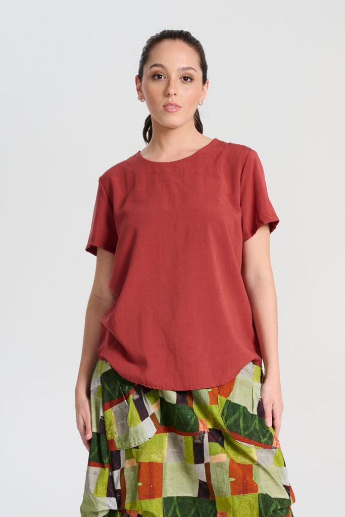 Olga de Polga Rhea Top in Rust. 100% Tencel. Round neckline and short sleeves. A boxy t-shirt shape in a soft silky Tencel fabric. Front close-up view