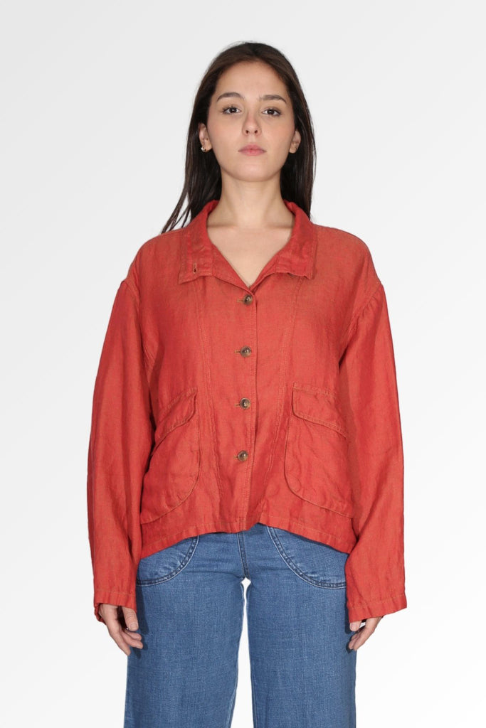 Olga de Polga Linen jacket crafted from a luxurious 100% linen fabric. In Tamarillo - a burnt orange shade with a slight textured feel. Long sleeves, large front patch pockets with flaps, a button front. Wear the collar all the way done up, or can be left open for a more casual look. Front view on model