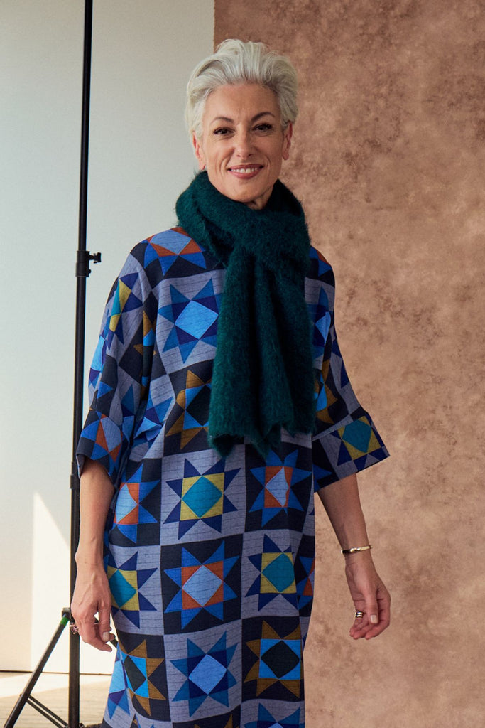 Olga de Polga Teal Aspen knit scarf in alpaca. Forest Green View on model. Crafted for warmth and timeless style, this luxuriously soft alpaca-blend scarf is a must-have for the cooler months. 