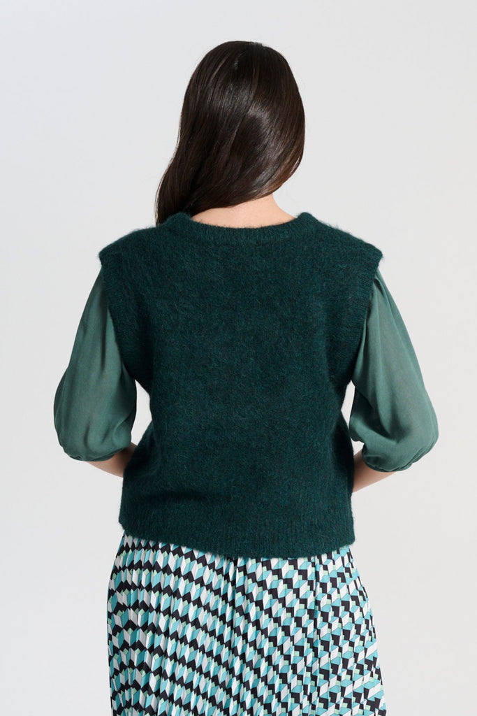 Olga de Polga Teal dark green Aspen Knit Vest in alpaca. A beautifully textured knit vest—your perfect layering essential for effortless, trans-seasonal styling.  Back view on model