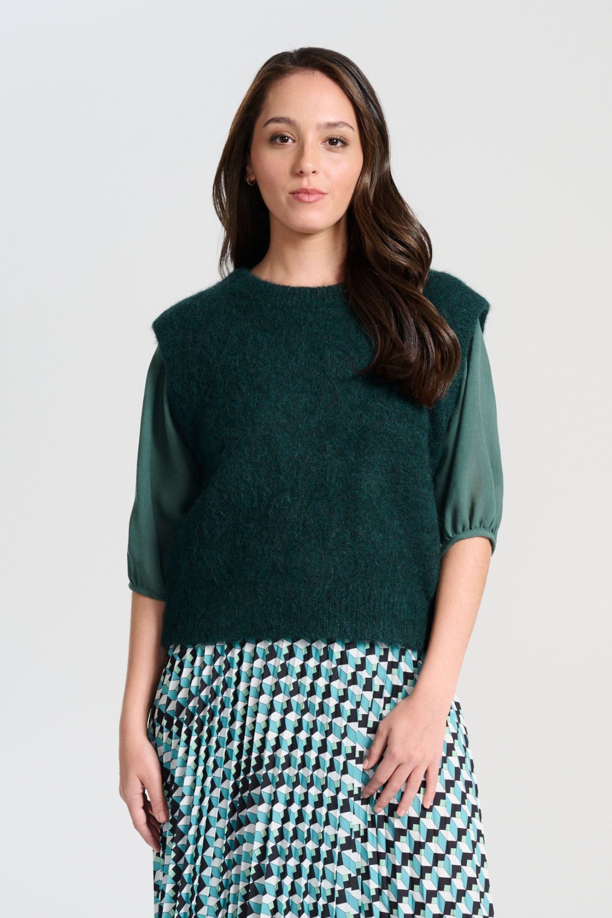 Olga de Polga Teal dark green Aspen Knit Vest in alpaca. A beautifully textured knit vest—your perfect layering essential for effortless, trans-seasonal styling. Front veiw on model.