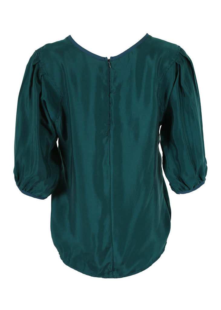 Olga de Polga classic blouse in Teal Bordeaux Cupro Twill, with a round neckline and half sleeves, this blouse finishes at the hip. Back view