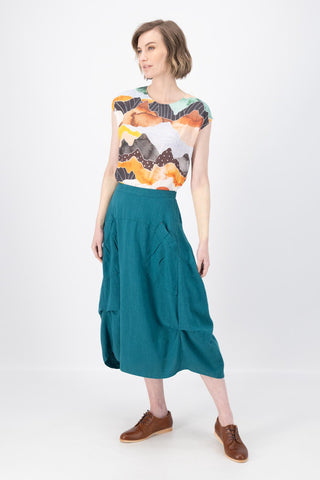 Olga de Polga Milwaukee Fiesta Teal skirt in 100% slub linen.  Our Milwaukee Fiesta skirt is an incredibly unique, chic and original skirt. It is universally flattering, highly versatile, and super comfortable. Perfect to throw on and go. Front full length view on model.