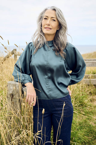 Olga de Polga Teal Moonshine Blouse in satin viscose. With billowing sleeves and a high neckline, this is a perfect date night go-to. Front close up view