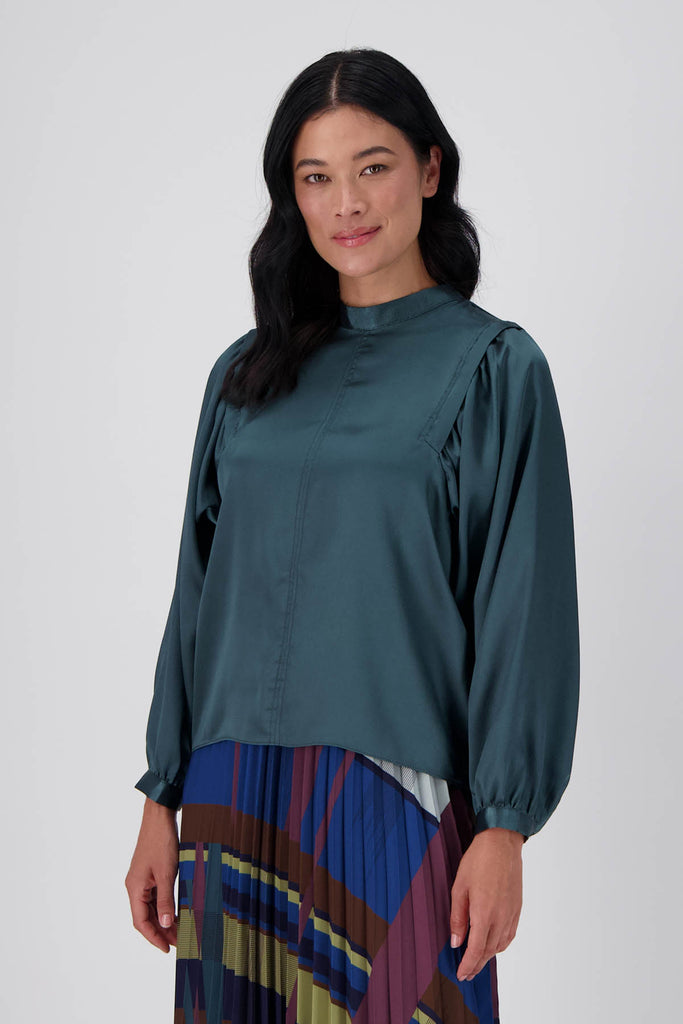 Olga de Polga Teal Monnshine Blouse in satin viscose. With billowing sleeves and a high neckline, this is a perfect date night go-to.  Side front view