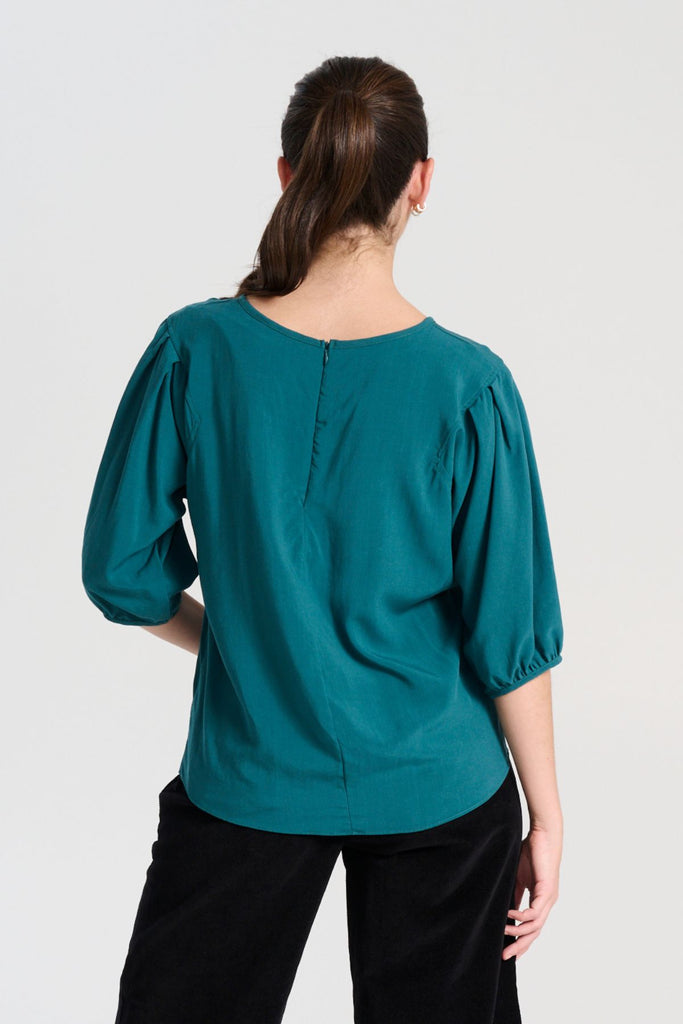 Olga de Polga Teal Rhea blouse in 100% fine Tencel.  Round neckline, half sleeves, finishes at the hip. Back view on model
