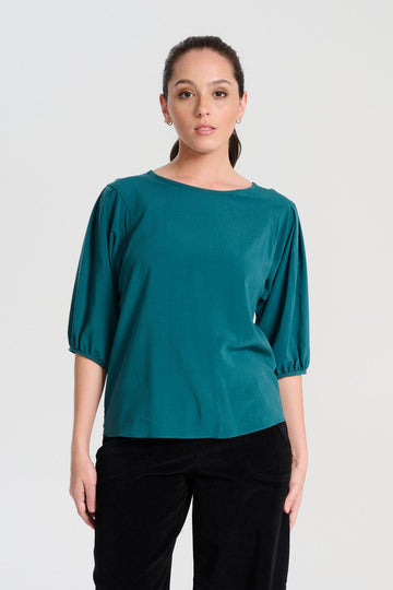 Olga de Polga Teal Rhea blouse in 100% fine Tencel.  Round neckline, half sleeves, finishes at the hip. Front view on model.