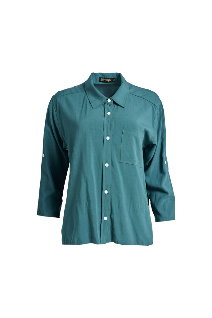 Olga de Polga Teal Rhea shirt in 100% soft Tencel. The front of the shirt sits at the waist while the back falls to the hips for a lovely drape. Perfect for leaving loose over pants or for tucking into any bottoms. Front view