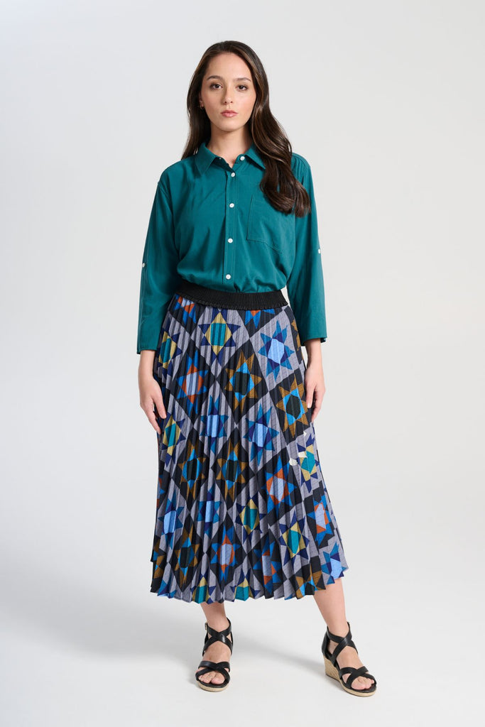 Olga de Polga Teal Rhea shirt in 100% soft Tencel. The front of the shirt sits at the waist while the back falls to the hips for a lovely drape. Perfect for leaving loose over pants or for tucking into any bottoms. Full length view on model.