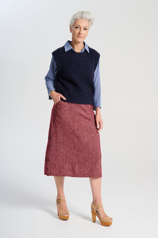 Olga de Polga Hepburn Haven skirt in Vino wool/linen. Unique front button feature, and has a back split. Finishes below the knee. Front view on model