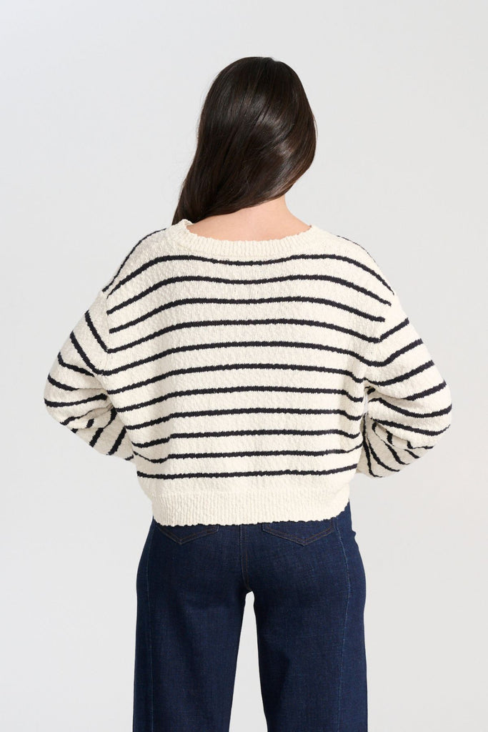 Olga de Polga White Captains Knit Sweater with thin nautical stripes. Round neckline. Long sleeves and a cropped body which drapes longer at the sides. Back view on model