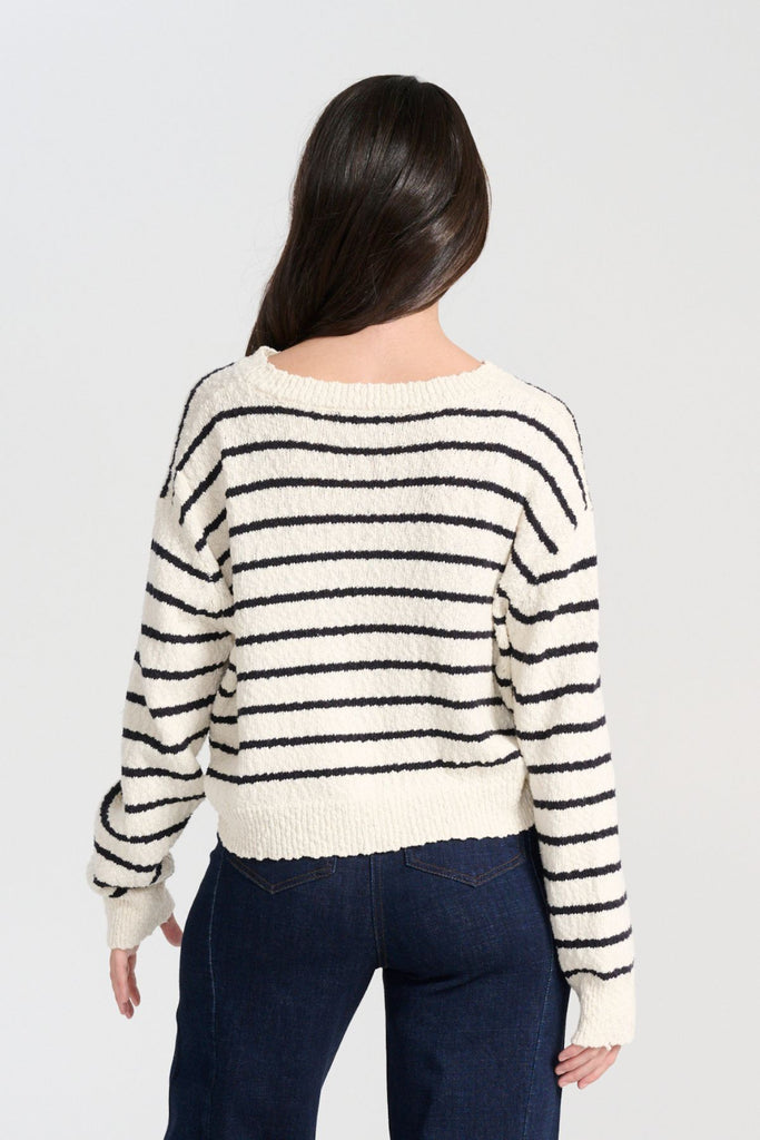 Olga de Polga White Captains Knit Sweater with thin nautical stripes. Round neckline. Long sleeves and a cropped body which drapes longer at the sides. Back view on model