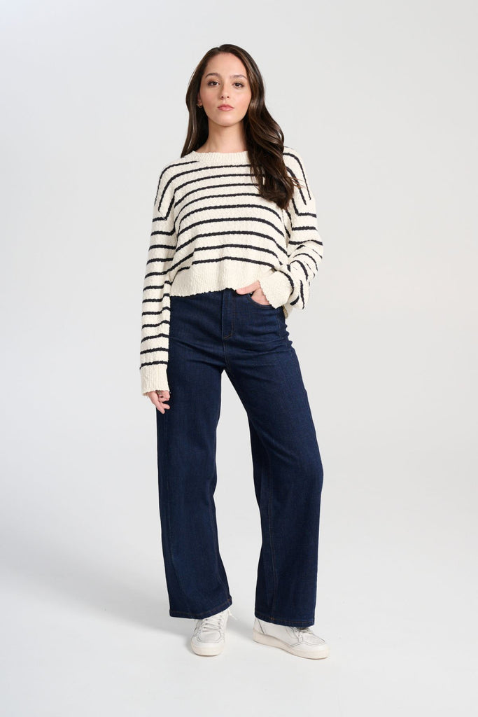 Olga de Polga White Captains Knit Sweater with thin nautical stripes. Round neckline. Long sleeves and a cropped body which drapes longer at the sides. Front full length view on model