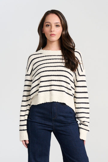 Olga de Polga White Captains Knit Sweater with thin nautical stripes. Round neckline. Long sleeves and a cropped body which drapes longer at the sides. Front close view on model