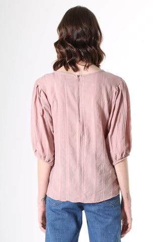 Olga de Polga Blouse in Avenida Textured cotton pink musk. the blouse features a beautifully detailed lantern sleeve with a drop shoulder and delicate pleating on the shoulder and cuff. It also has a wide boat neckline and invisible zip fastening at the back.