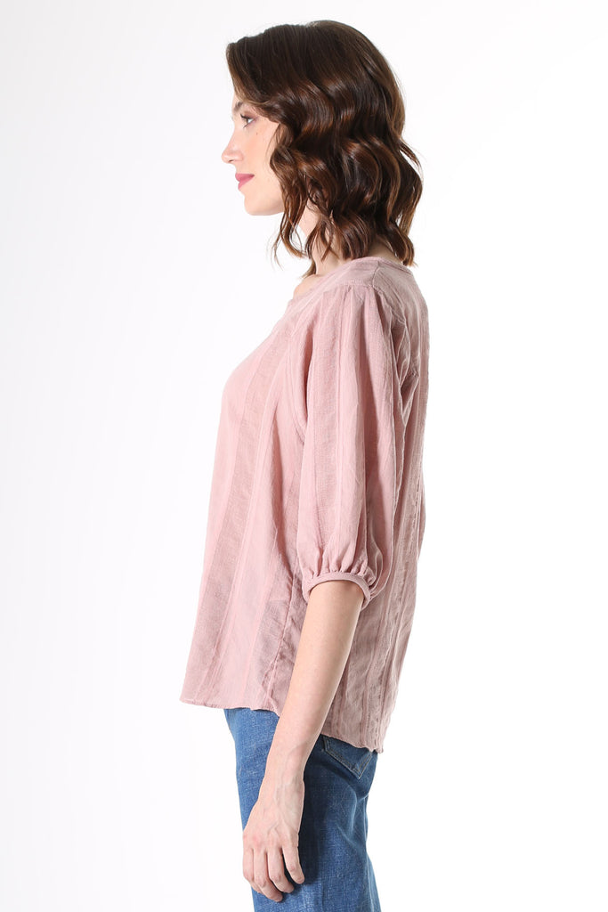 Olga de Polga Blouse in Avenida Textured cotton pink musk. the blouse features a beautifully detailed lantern sleeve with a drop shoulder and delicate pleating on the shoulder and cuff. It also has a wide boat neckline and invisible zip fastening at the back.