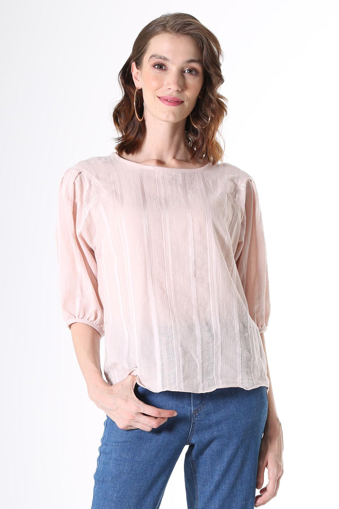 Olga de Polga Blouse in Avenida textured cotton pale pink. the blouse features a beautifully detailed lantern sleeve with a drop shoulder and delicate pleating on the shoulder and cuff. It also has a wide boat neckline and invisible zip fastening at the back.