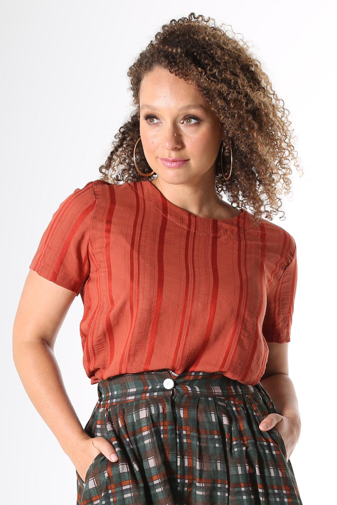 Olga de Polga top in Avenida textured cotton in Terracotta orange colour. Top is straight cut, with a short sleeve, crew neck and a box pleat at the back to give it more fullness and movement.  