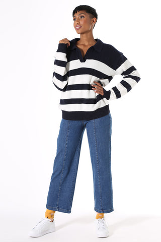 Olga de Polga Coota Long Striped Sweater. Blending the relaxed fit of a polo sweater with the luxury of cashmere, this is the perfect weekend knit. Long length that falls below the hip, relaxed fit, with an open collar, v-neck and dropped shoulder. Patterned with wide and narrow horizontal navy stripes.