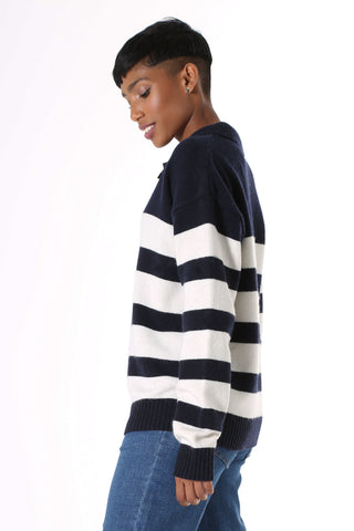 Olga de Polga Coota Long Striped Sweater. Blending the relaxed fit of a polo sweater with the luxury of cashmere, this is the perfect weekend knit. Long length that falls below the hip, relaxed fit, with an open collar, v-neck and dropped shoulder. Patterned with wide and narrow horizontal navy stripes.