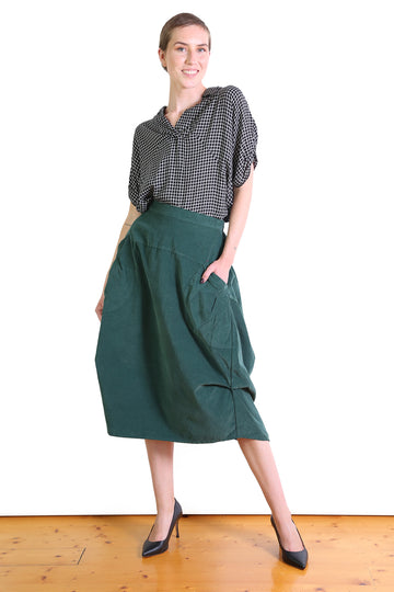 Olga de Polga best seller the Milwaukee skirt in fine cord. Colour dark green. 100% cotton. Front view on model