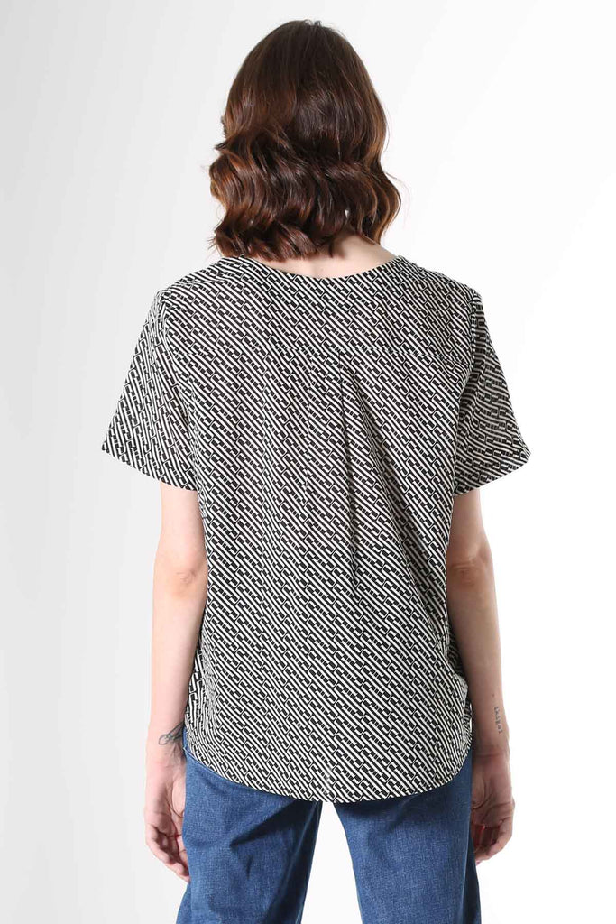 Olga de Polga Top with a straight cut, with a short sleeve, crew neck and a box pleat at the back to give it more fullness and movement.  A modern unique graphic print in black and beige. Soft, light-weight cotton/rayon fabric with a floaty drape.   