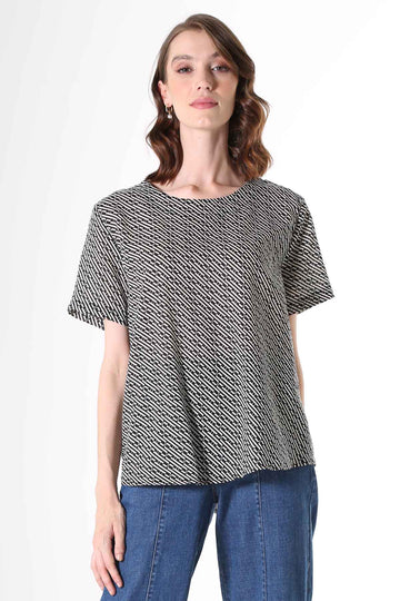 Olga de Polga Top with a straight cut, with a short sleeve, crew neck and a box pleat at the back to give it more fullness and movement.  A modern unique graphic print in black and beige. Soft, light-weight cotton/rayon fabric with a floaty drape.    