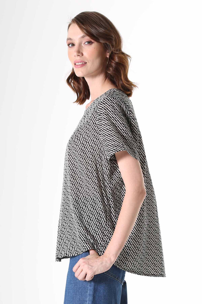 Olga de Polga Top with a straight cut, with a short sleeve, crew neck and a box pleat at the back to give it more fullness and movement.  A modern unique graphic print in black and beige. Soft, light-weight cotton/rayon fabric with a floaty drape.   