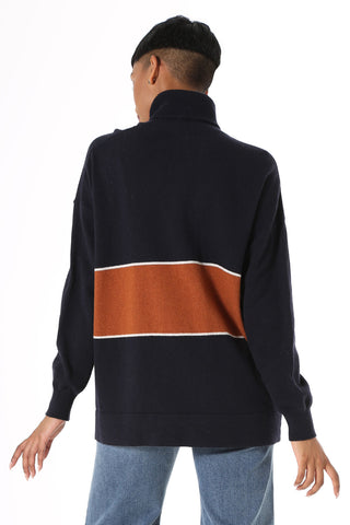 Olga de Polga Mariana Turtleneck sweater Navy. Oversized long length boyfriend style knit, with rolled turtleneck and dropped shoulder. Fine light-weight wool viscose. Featuring a wide stripe with a fine white border.