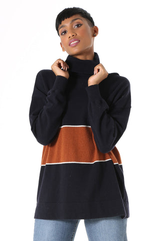 Olga de Polga Mariana Turtleneck sweater Navy. Oversized long length boyfriend style knit, with rolled turtleneck and dropped shoulder. Fine light-weight wool viscose. Featuring a wide stripe with a fine white border.