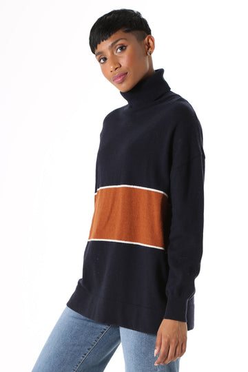 Olga de Polga Mariana Turtleneck sweater Navy. Oversized long length boyfriend style knit, with rolled turtleneck and dropped shoulder. Fine light-weight wool viscose. Featuring a wide stripe with a fine white border.