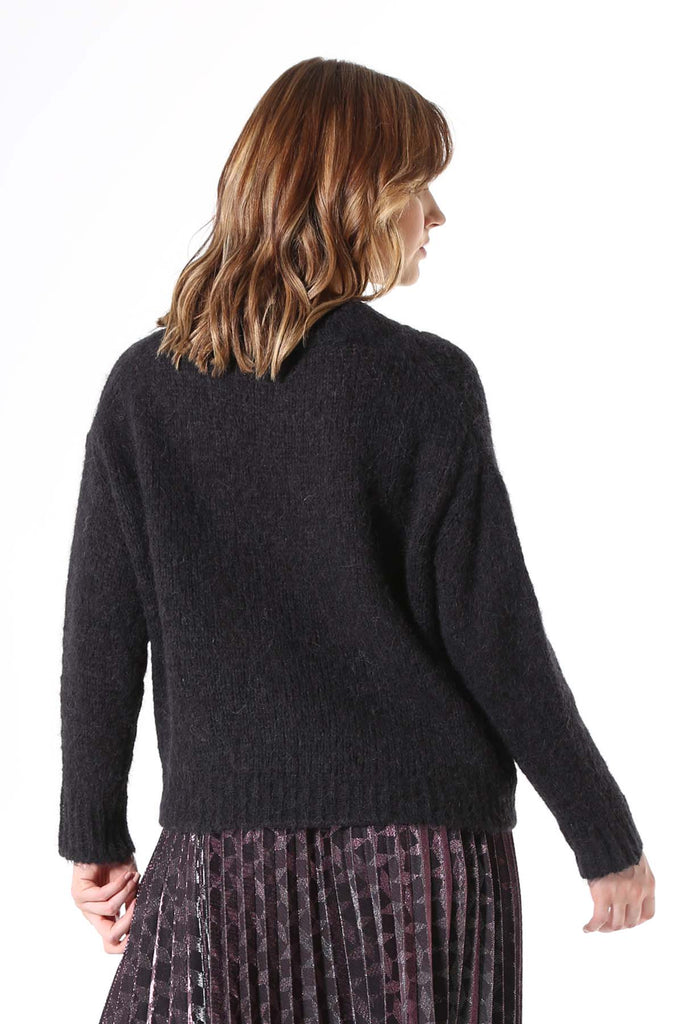 Olga de Polga Copenhagen knit sweater in black with long sleeves and a crew neckline. Back view worn by model