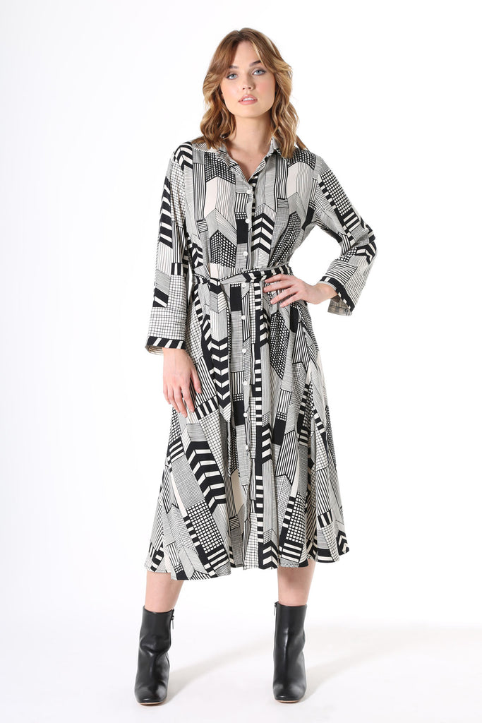 Olga de Polga Metro printed black and white shirt dress. Classic midi-length, shirt dress with slightly dropped shoulder, buttons all the way through from collar to hem, wide wrist length cuffs, a-line skirt and an elegant waist tie.
