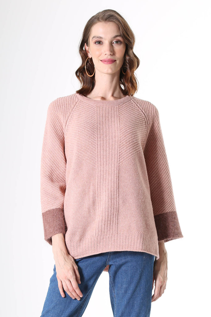 Olga de Polga Starburst Sweater in Pink. A longline sweater with an air of retro chic, the Starburst Sweater features a flared raglan sleeve with contrasting angora cuff detail, a rounded neckline and side splits to the hip. The back has an angora zip pull and metal zip closure and is slightly longer than the front.