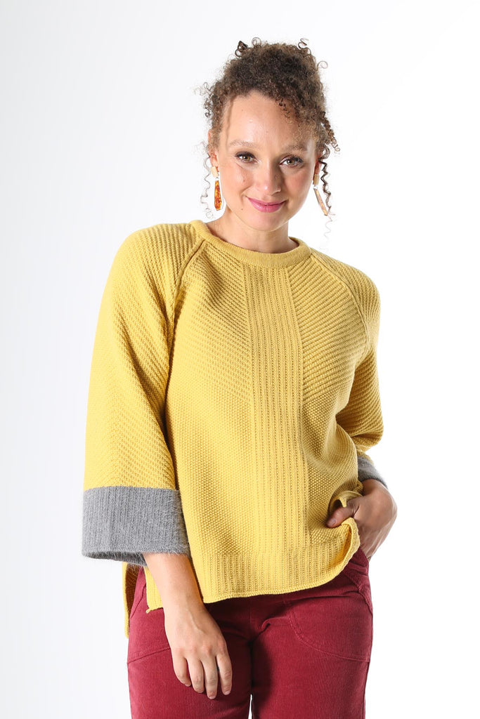 Olga de Polga Starburst Sweater Yellow. A longline sweater with an air of retro chic, the Starburst Sweater features a flared raglan sleeve with contrasting angora cuff detail, a rounded neckline and side splits to the hip. The back has an angora zip pull and metal zip closure and is slightly longer than the front. 