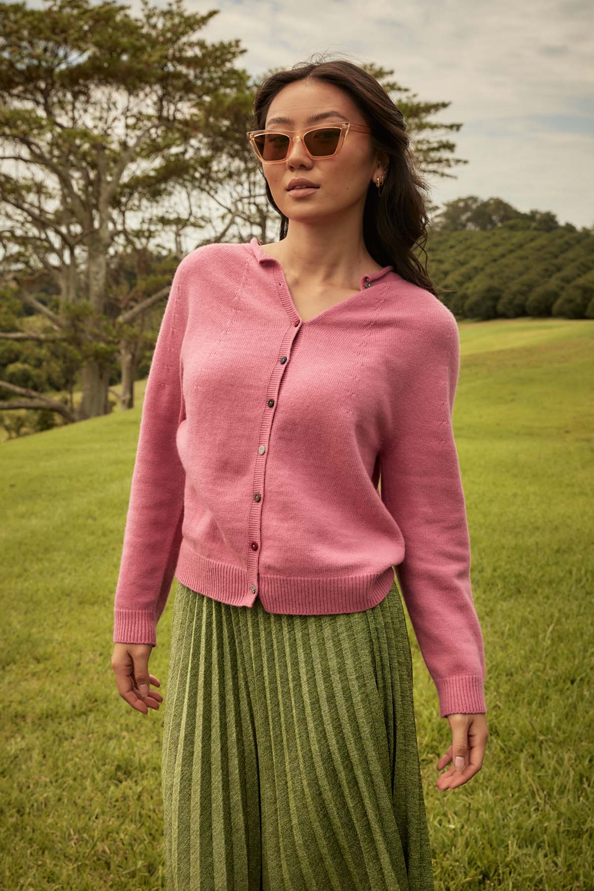 Olga de polga Lucy Lurex pleat skirt in green colour. Flattering black elastic waistband. Front view on model